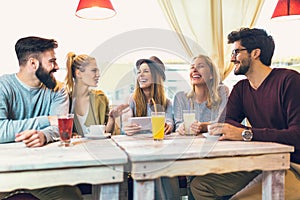 Group of five friends having a coffee together.