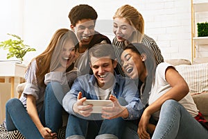 Group of Five Friends Laughing and Sharing a Fun Moment