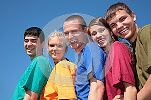 Group of five friends in multicolor shirts