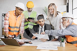 Group of five multi ethnic people cooperating together.