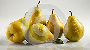 a group of five pears sitting on top of each other on a white surface with water droplets on the pears and leaves on the top of