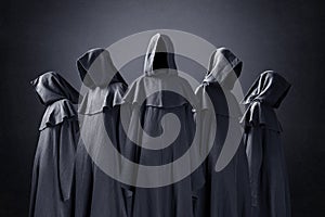 Group of five scary figures in hooded cloaks