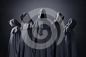 Group of five scary figures in hooded cloaks photo
