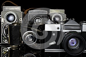 Vintage antique camera isolated on black glass