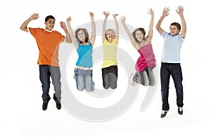 Group Of Five Young Children Jumping In Studio