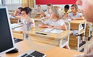 Group of focused children working at class
