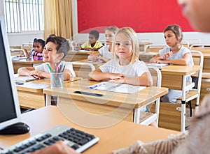 Group of focused children working at class