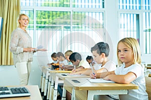 Group of focused kids working at class