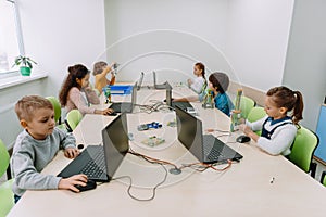 group of focused kids working with computers photo