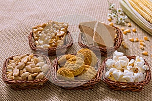 Group of food of Festa Junina in wicker baskets, typical brazilian party: Peanut, Cookie, Popcorn, Pe de Moleque, Pacoca, Corn. J