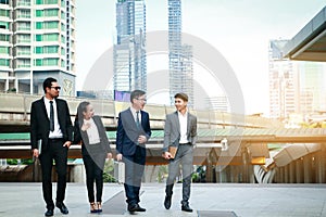 A group of four Asian businessmen Standing meeting for discussions on real estate investment in Asia.