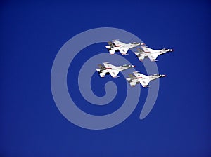 Group of four fighter jets flying in formation