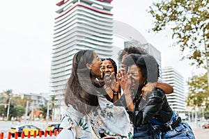 Group of four friends is caught in a moment of spontaneous laughter.