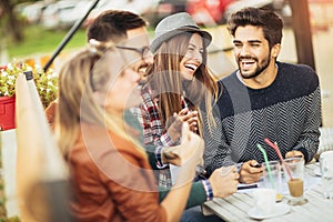 Group of four friends having a coffee together.