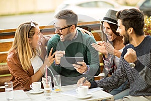 Group of four friends having a coffee together.