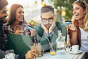 Group of four friends having fun a coffee together