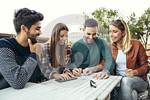 Group of four friends having fun a coffee together.