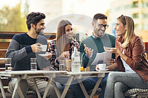 Group of four friends having fun a coffee together. an