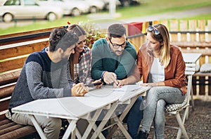 Group of four friends having fun a coffee together.