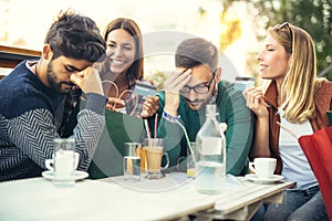 Group of four friends having fun a coffee together in