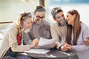 Group of four friends having fun a coffee together.