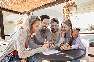 Group of four friends having fun a coffee together.