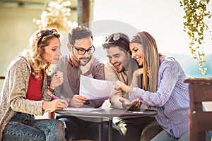 Group of four friends having fun a coffee together.