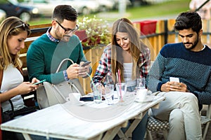 Group of four friends having fun a coffee together.