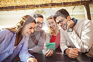 Group of four friends having fun a coffee together.