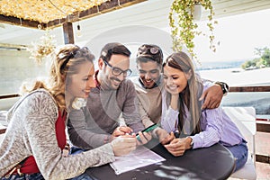 Group of four friends having fun a coffee together