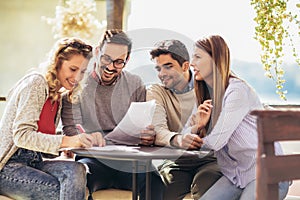 Group of four friends having fun a coffee together.