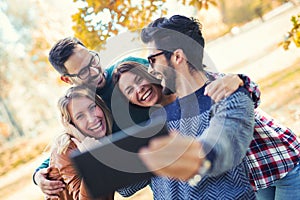 Group of four funny friends taking selfie
