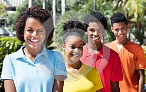 Group of four happy latin american young adult in line