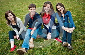 Group of Four happy teenagers outside