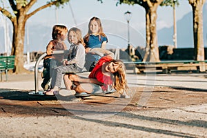 Group of four kids having fun on playground