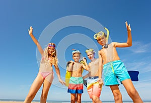 Group of four kids together portrait on the beach