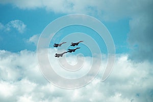 Group of four military aircraft of fighters, jet airplane in the sky make maneuvers