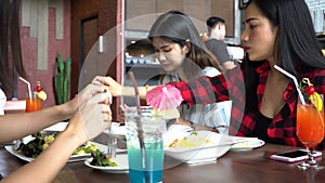Group of Four young Asian people, eating and talking at cafe and restaurant. Friendship concept