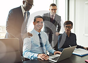 Group of four young business people in office