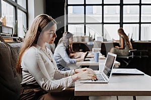 Group of freelancers and remote businesspeople working in shared work area. Concept of coworking, common workspaces for