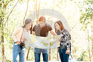 Group of Freind reading map on country walk