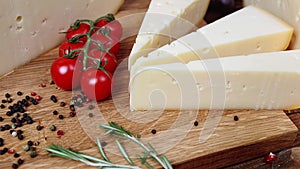 Group of french aged delicatessen cheeses on wooden table intro motion slow hidef hd