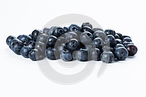 A group of fresh blue berries close-up, isolated on a white background.