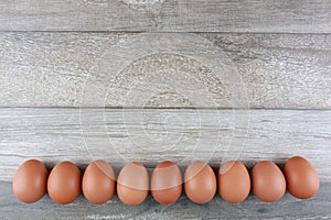 Group of fresh chicken eggs from farm on vintage wooden table background. Advertising image food concept with free space