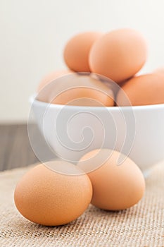 Group of fresh chicken eggs in white bowl