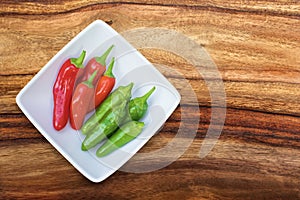 Group of fresh chili`s in a white bowl viewed from the top with