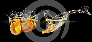 Group of fresh fruits falling in water with splash on black background