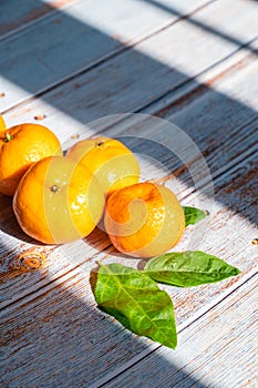 Group of fresh orange fruits on wooden board background