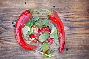 Group of fresh red hot chilli peppers on an old vintage wooden table