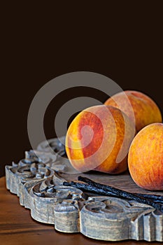 Group OF Fresh Ripe Peaches With Vannilla Beans On Wooden Platter